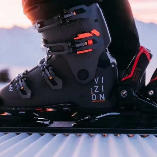 Snowboard boot in bindings at sunset