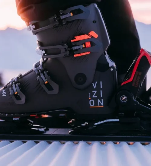 Snowboard boot in bindings at sunset
