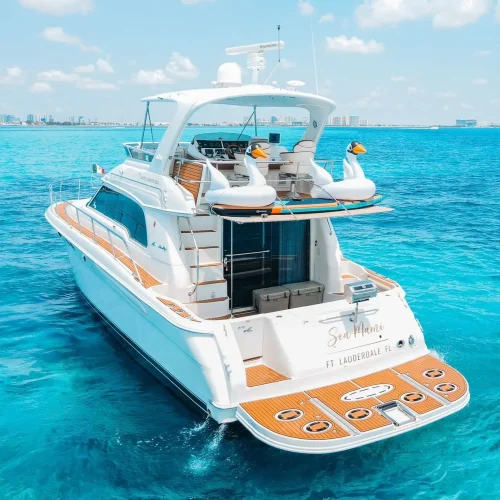 Stern view of Sea Mami yacht anchored in bright turquoise Cancún waters.