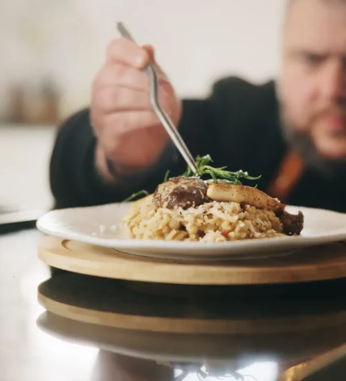 Presentation, plate or hands of man with food in kitchen of home for diet, service or nutrition. Ingredients, risotto recipe or person with dish design for gourmet cuisine, cooking mushroom or lunch
